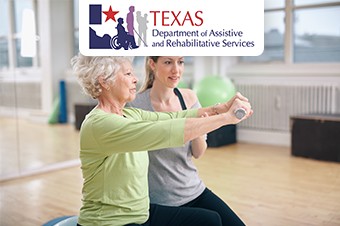 Senior woman being assisted by instructor in lifting dumbbells at gym. Senior woman training in the gym with a personal trainer at rehab.